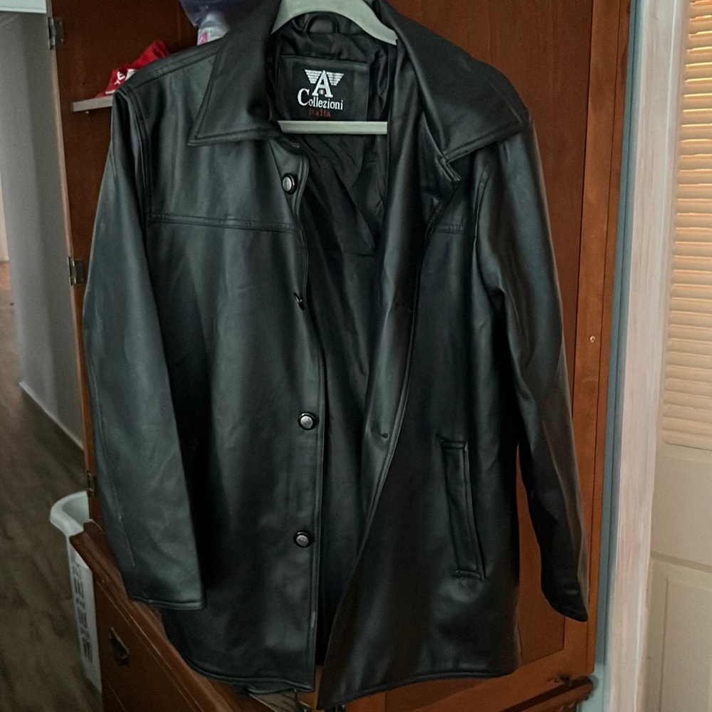 Black leather jacket with buttons. New never worn.